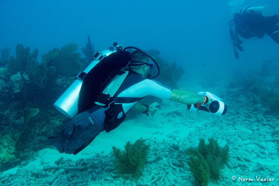 Combat wounded SCUBA diver underwater using scooter since he has no legs to propel himself.